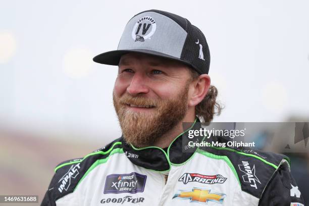 Jeffrey Earnhardt, driver of the Jesus Revolution - The Movie Chevrolet, waits on the grid prior to the NASCAR Xfinity Series Production Alliance...