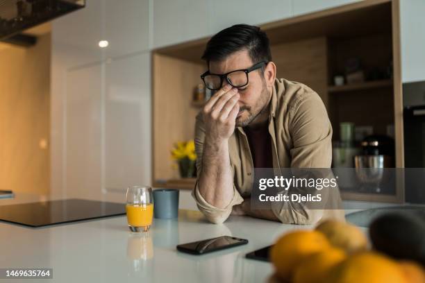 depressed man having problems at home. - man cry touching stock pictures, royalty-free photos & images