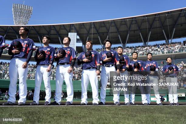 Samurai Japan players line up for the national anthem prior to the practice game between Samurai Japan and Fukuoka SoftBank Hawks at Hinata Sun...