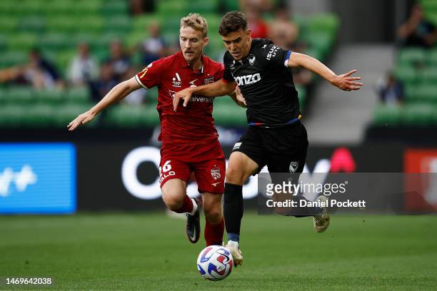 Enrique Lopez of the Victory and Ben Halloran of Adelaide United contest the ball during the round 18 A-League Men's match between Melbourne Victory...