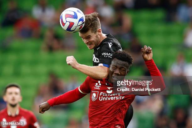 Connor Chapman of the Victory and Nestory Irankunda of Adelaide United contest the ball during the round 18 A-League Men's match between Melbourne...