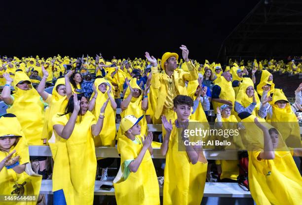Savannah Bananas owner Jesse Cole leads the cheers with the fans during their home opener against the Party Animals at Grayson Stadium on February...