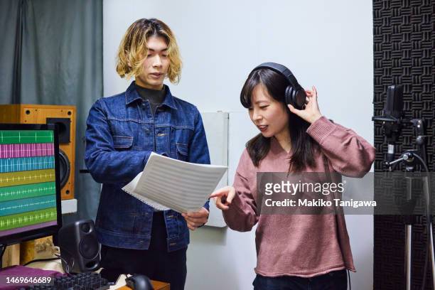 young woman taking vocal lesson - makiko tanigawa stock-fotos und bilder