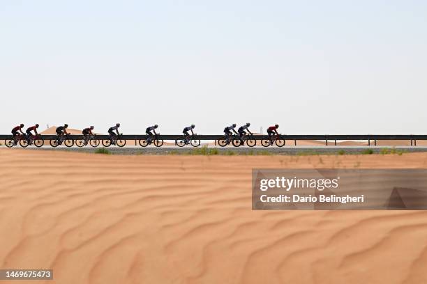 Remco Evenepoel of Belgium and Team Soudal Quick-Step - Red Leader Jersey and a general view of the peloton competing through the desert during the...