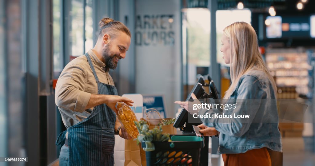 Grocery store, food market payment and customer with supermarket employee at check out. Retail discount, cash register and product promotion with a woman at a store counter paying for groceries