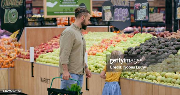 girl, father and grocery shopping for fruit in store for food, products and groceries basket. sales deals, family discount and child or kid with man in supermarket for buying avocados for nutrition. - father with kids grocery shopping stock pictures, royalty-free photos & images