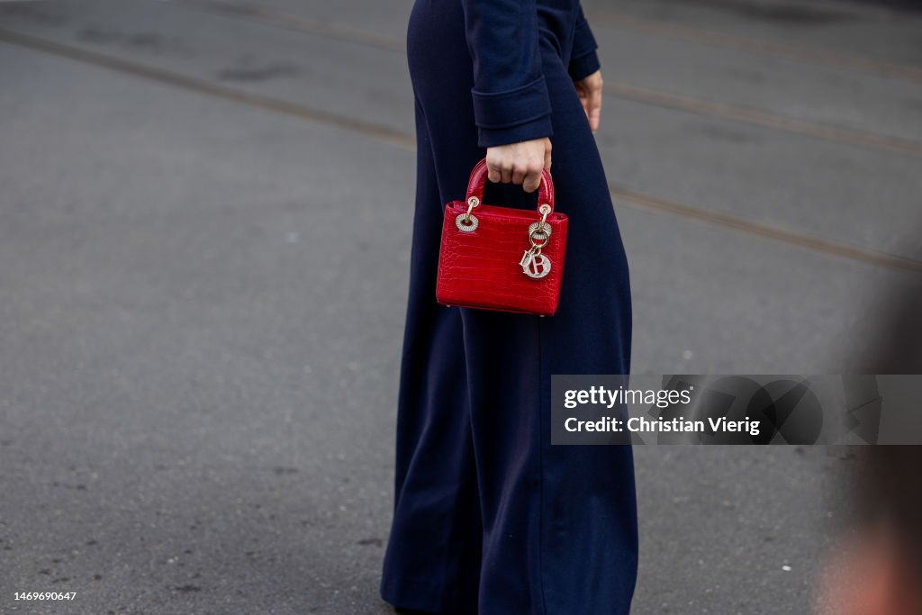 A guest wears red Dior bag outside Bally during the Milan Fashion News  Photo - Getty Images