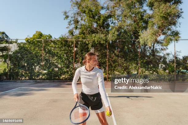 female tennis player on court - doubles sports stock pictures, royalty-free photos & images