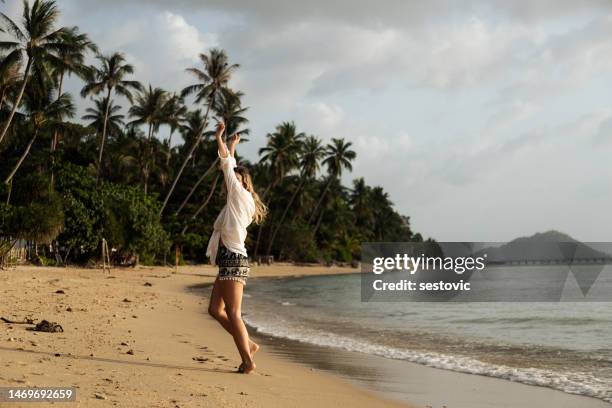 woman walking on beach at sunset, koh phangan, thailand - strand pattaya stockfoto's en -beelden