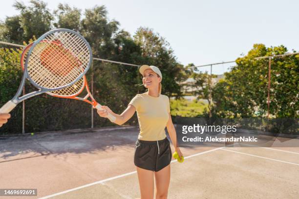 loving couple playing tennis together - tennis outfit stock pictures, royalty-free photos & images