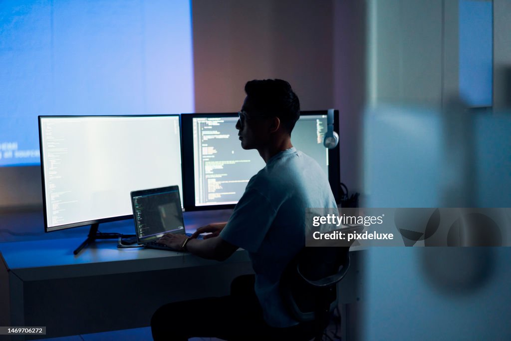 Web design, coding and Asian man with a computer for programming a website at night. Cyber security, developer and programmer reading information for a software database on a pc in a dark office