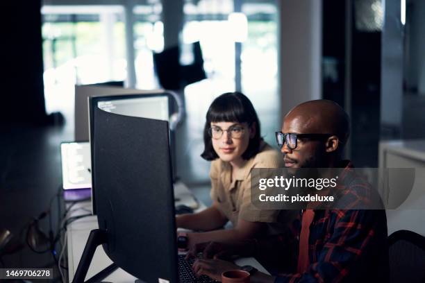 developers, coding and programming at night on computer in software or application development at office. man and woman code on desktop pc working late in team testing, security or online networking - webdesigner stockfoto's en -beelden