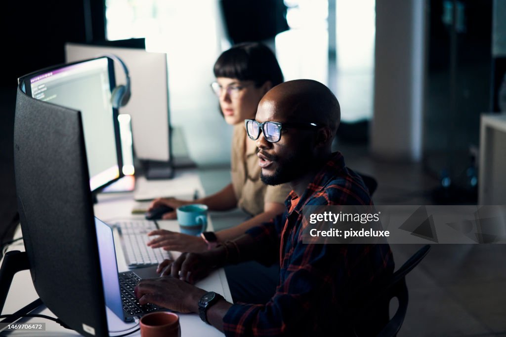 Creative developers, coding and programming on computer in software or application development at office. Man and woman code on laptop or technology for testing, web design or online networking