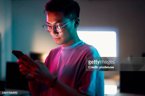 asian man, phone or programming in night office of software development, cybersecurity review or database code safety. programmer, developer or engineer on neon technology, web 3.0 coding or thinking - color boost imagens e fotografias de stock
