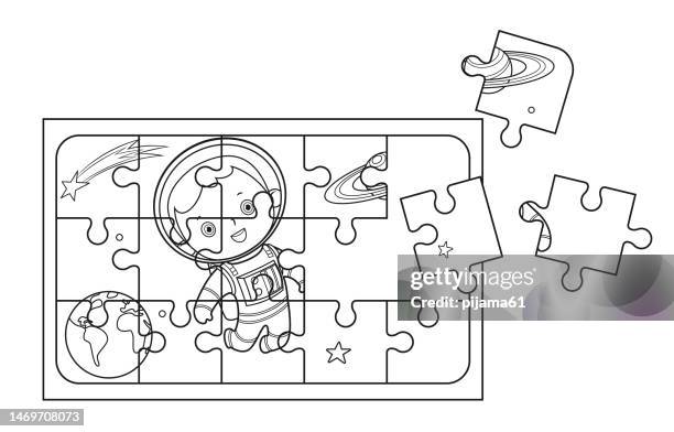 black and white jigsaw - boy astronaut stock illustrations