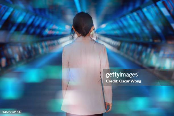 rear view of young asian business woman using entering a virtual reality (vr) world - woman entering stock pictures, royalty-free photos & images