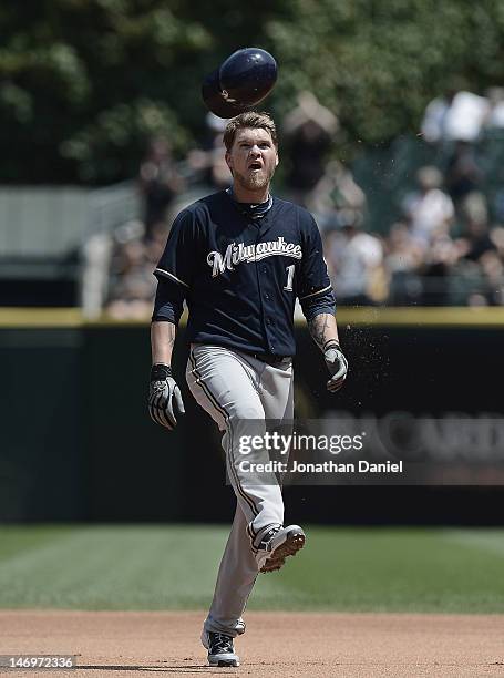 Corey Hart of the Milwaukee Brewers kicks his batting helmut after being robbed of a home run on a catch by Alex Rios of the Chicago White Sox during...