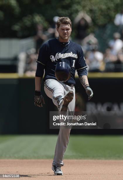 Corey Hart of the Milwaukee Brewers kicks his batting helmut after being robbed of a home run on a catch by Alex Rios of the Chicago White Sox during...