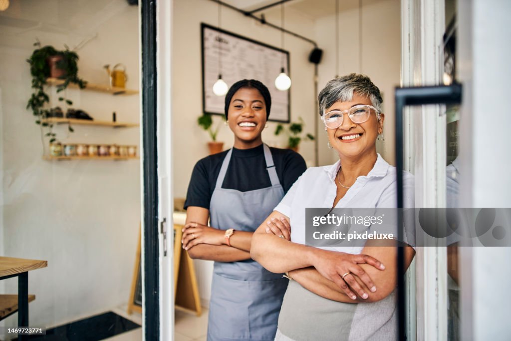 Coffee shop, senior woman manager portrait with barista feeling happy about shop success. Female server, waitress and small business owner together proud of cafe and bakery growth with a smile