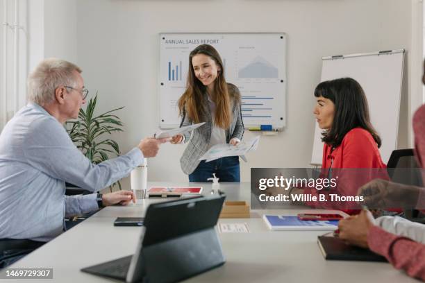 businesswoman handing out notes during meeting - hands explaining stock pictures, royalty-free photos & images