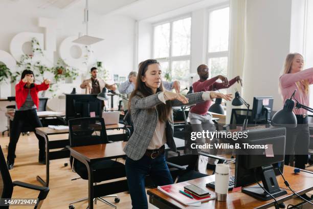 group of business colleagues doing yoga at the office - woman and tai chi stock pictures, royalty-free photos & images