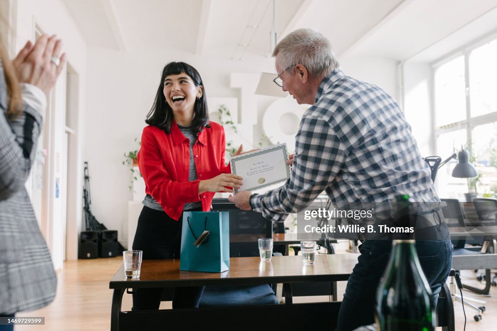 Businesswoman Receiving Certificate At The Office