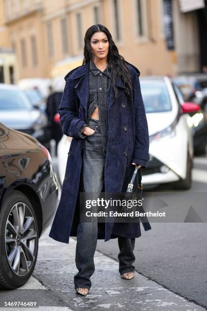Guest wears a navy blue suede long coat, a gray denim with black rhinestones shirt from Bally, matching gray denim with black rhinestones flared...