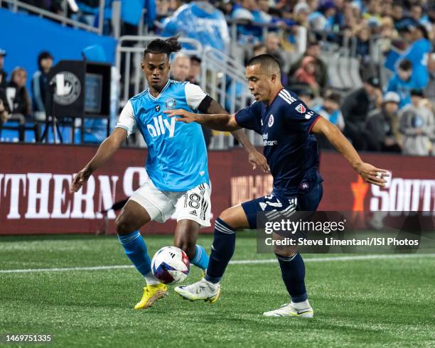 Kerwin Vargas of Charlotte FC and Bobby Wood of New England Revolution vie for the ball during a game between New England Revolution and Charlotte FC...