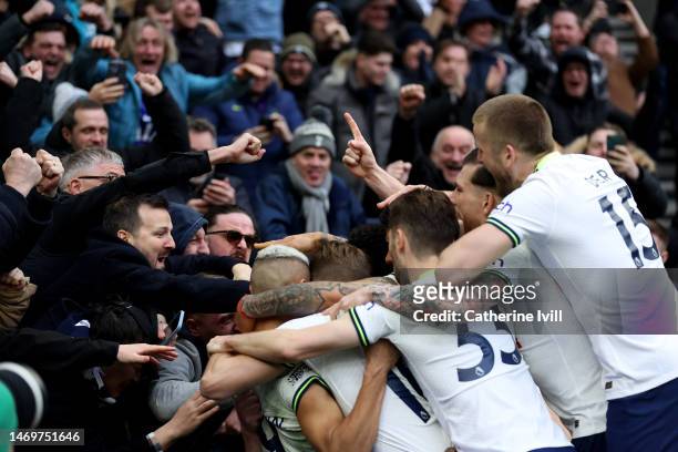 Oliver Skipp of Tottenham Hotspur celebrates after scoring the team's first goal with teammates and the fansduring the Premier League match between...