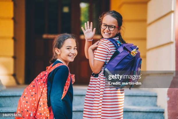 schoolgirls smiling to camera - first day of school bildbanksfoton och bilder