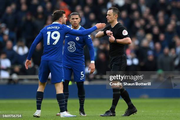 Referee, Stuart Attwell prepares to show a yellow card to Mason Mount of Chelsea during the Premier League match between Tottenham Hotspur and...