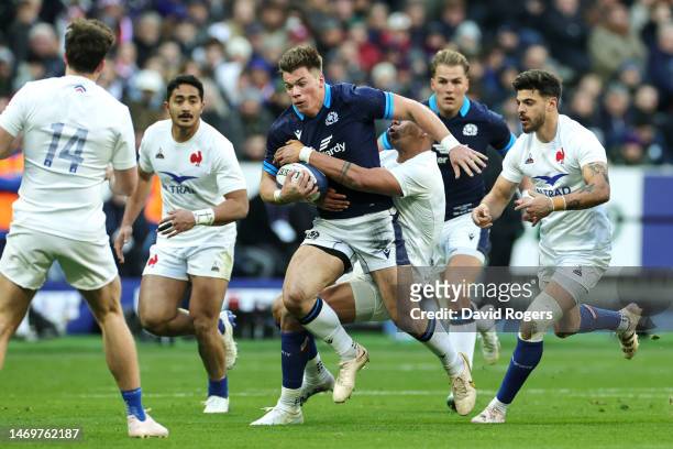 Huw Jones of Scotland is tackled by Gael Fickou of France during the Six Nations Rugby match between France and Scotland at Stade de France on...