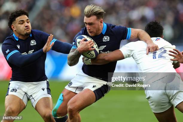Stuart Hogg of Scotland is tackled by Yoram Falatea-Moefana of France during the Six Nations Rugby match between France and Scotland at Stade de...