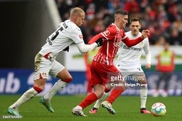 Roland Sallai of Sport-Club Freiburg is put under pressure by Mitchel Bakker of Bayer 04 Leverkusen during the Bundesliga match between Sport-Club...