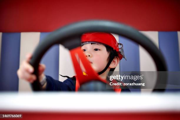 children imitation firefighter driving fire-truck - boy fireman costume stock pictures, royalty-free photos & images