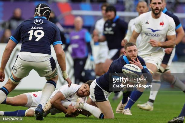 Finn Russell of Scotland offloads the ball during the Six Nations Rugby match between France and Scotland at Stade de France on February 26, 2023 in...