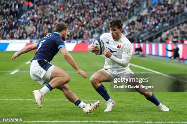 Ethan Dumortier of France is put under pressure by Ben White of Scotland during the Six Nations Rugby match between France and Scotland at Stade de...