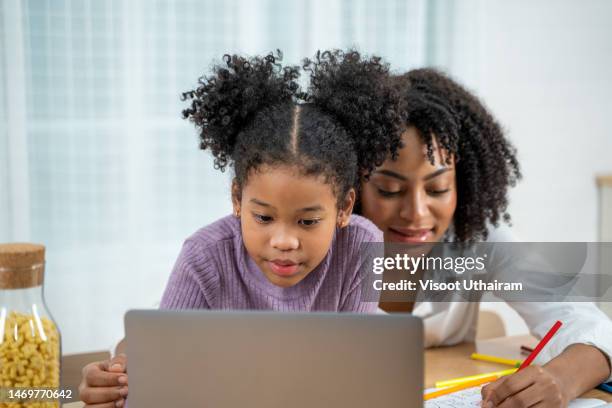 african american girl enjoy watching funny video or learning online class. - two women looking at phone or tablet isolated photos et images de collection