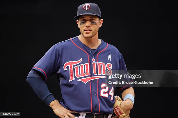 Trevor Plouffe of the Minnesota Twins talks with the third base coach for the Milwaukee Brewers on June 17, 2012 at Target Field in Minneapolis,...