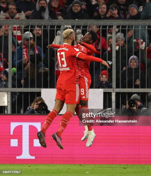 Eric Maxim Choupo-Moting of FC Bayern Munich celebrates with teammate Alphonso Davies after scoring the team's first goal during the Bundesliga match...