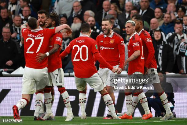 Marcus Rashford of Manchester United celebrates with Luke Shaw, Antony and teammates after scoring the team's second goal during the Carabao Cup...