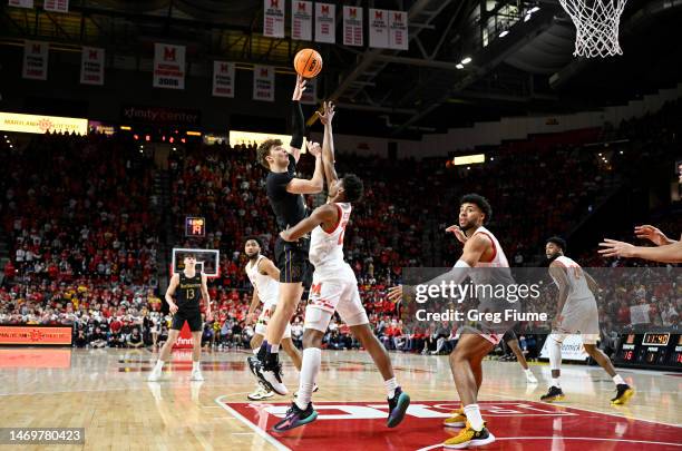 Nick Martinelli of the Northwestern Wildcats shoots the ball against Ike Cornish of the Maryland Terrapins in the first half of the game at Xfinity...