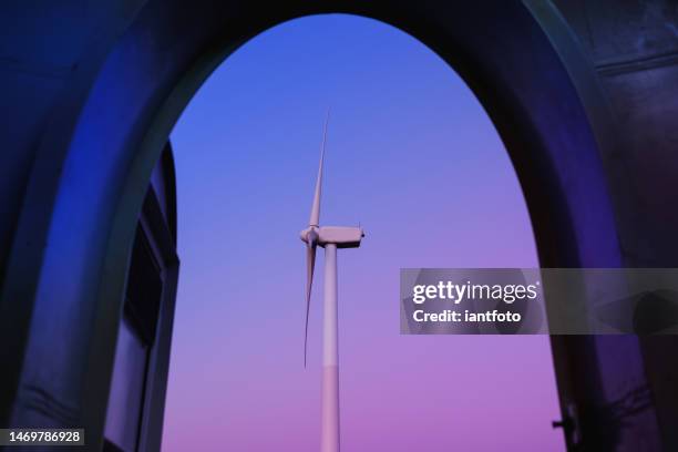 open the door to the wind turbine, in a purple and blue twilight. - energieindustrie stockfoto's en -beelden