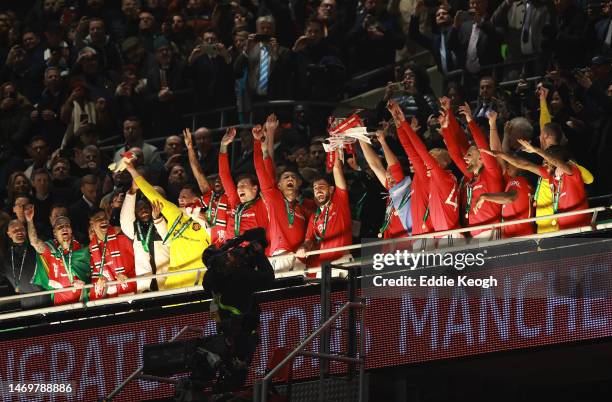 Bruno Fernandes and Harry Maguire of Manchester United lift the Carabao Cup trophy following victory in the Carabao Cup Final match between...