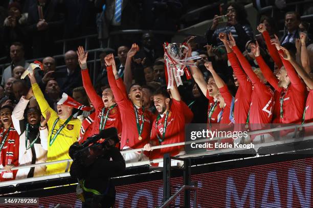 Bruno Fernandes and Harry Maguire of Manchester United lift the Carabao Cup trophy following victory in the Carabao Cup Final match between...