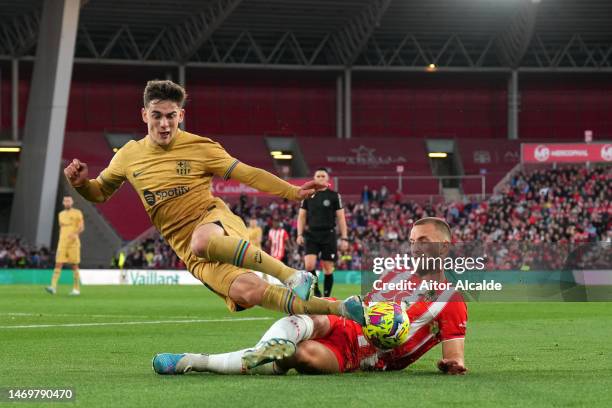 Gavi of FC Barcelona is tackled by Rodrigo Ely of UD Almeria during the LaLiga Santander match between UD Almeria and FC Barcelona at Juegos...