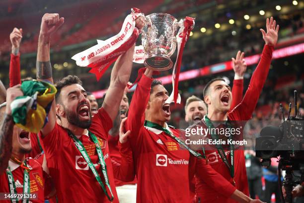 Bruno Fernandes and Raphael Varane of Manchester United celebrate with the Carabao Cup trophy following victory in the Carabao Cup Final match...