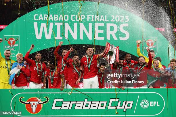 Bruno Fernandes and Harry Maguire of Manchester United lift the Carabao Cup trophy following victory in the Carabao Cup Final match between...