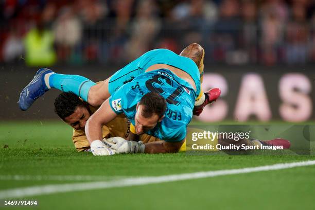 Fernando Martinez Rubio of UD Almeria competes for the ball with Raphinha of FC Barcelona during the LaLiga Santander match between UD Almeria and FC...