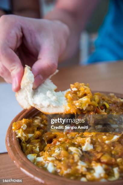 eating tunisian tebsi keftaji with a piece of bread - tunisia medina stock pictures, royalty-free photos & images